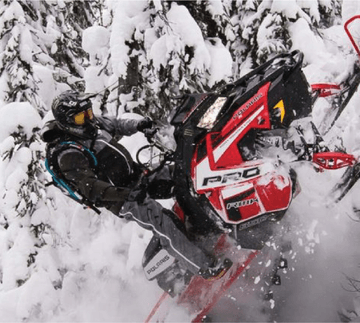 Athlete Brett Turcotte riding a Polaris snowmobile with an ArcticFX Graphics wrap